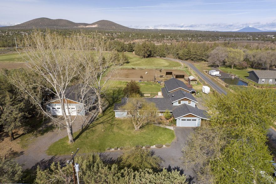 Welcome home to the Modern Day Walton's! Multi-generational living at it's very best! COMPLETELY updated with high end finishes throughout. From granite and quartz counters in kitchen and baths and beautiful plank flooring, ductless heating and cooling in all rooms, 5 dedicated bedrooms including the AMAZING ensuites with separate Living, Family rooms and office space, make this an incredibly versatile floorplan. And, This is only the beginning, Car enthusiasts and HOT Rodders will be at home in  the HUGE Finished and heated Auto-shop with 3 10x10 doors and separate work spaces. Outside, you will find colorful and mature landscaping, with an acre of irrigation and an over-sized paver patio for entertaining, fenced and cross-fenced, with corrals and lean-to shelters for 4-h animals,  walking distance to the Deschutes River and Cline Falls St Park, this property is centrally located with ez access to all Central Oregon has to offer.