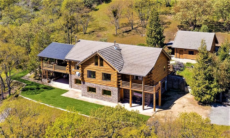 This top quality, Homestead Log home is a lovely mountain getaway and yet less than 10 minutes from downtown. The 12.8 acres ensures privacy and backs up to BLM land which offers endless trails for exploring. One of the things that makes this house truly unique is how strong it is built. The 9' concrete perimeter foundation and reinforced re-bar exceeds code. Don't like paying a lot for electricity? The house Includes a woodchuck HVAC system for going off grid and years worth of supplies for it (currently disconnected). For living on grid there is a brand new HVAC system that was installed in 2018. Great for a two-family set-up as there are 3 bdrms, 2 baths, living area, kitchen, and laundry upstairs and a separate living area downstairs with kitchenette, 2 bdrms and 2 baths. The downstairs has its own entrance but can also be accessed from the first level. Large, covered deck great for outdoor entertaining, plus 2 covered storage areas and a 2-car garage! Amazing views & ready to go!