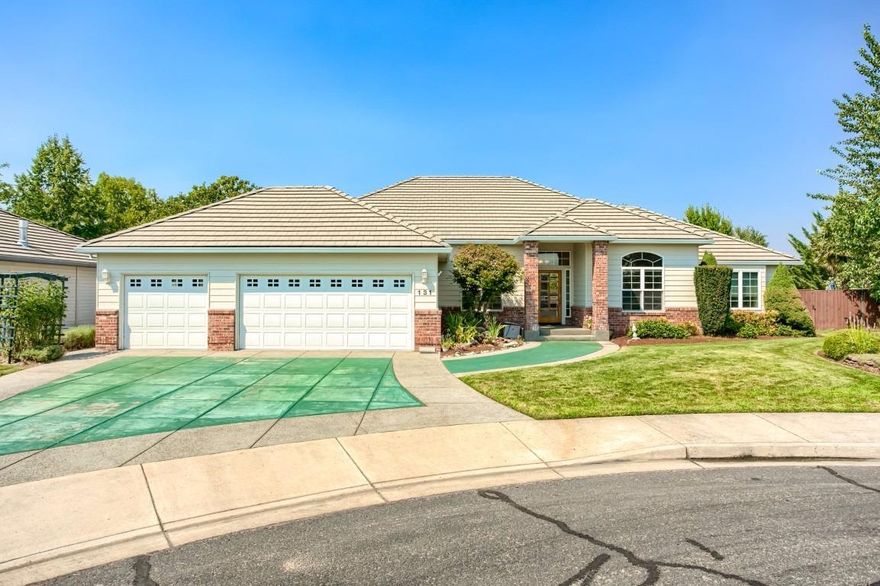 What a rare find in the heart of the Eagle Point Golf Course Community, packed with value and totally move in ready! This single level home offers nearly 2,200 sf of open living, a 3-car garage, tile roof, central vac, vaulted ceilings, gas fire place, plus new hardwoods and carpet throughout. The floor plan is a desirable split layout with spacious master including full en suite on one side, and 2 bedrooms with a Jack and Jill bath on the other (there's also a 1/2 bath for guests). Outside you'll enjoy the covered patio, beautiful in ground pool and hot tub, it's one of very few homes in the EPGC with a pool, especially at this price! Throw in the fridge, washer and dryer and this home is priced to sell! All of this in a quiet cul-de-sac location just 2 blocks from the cart path and minutes from the club house. Don't let this one get away!