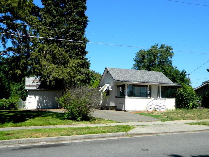 Covered front Porch.  A true fixer upper, Great Bones & Large lot.  Bring your dreams for a new home.  832 sqft,  2 bdrm 1 bath and large living room.  Kitchen has original cabinets,  bathroom will need some work. Just waiting for the right buyer to bring this home back to life. Detached garage.  Roof 2 years old.  Walnut & Cherry tree, grapes.  Selling as is with no repairs