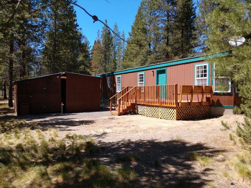 Ubur Clean well maintained manufactured home with some recent updates on nicely treed firesafe 1.34 acres is ready for occupancy. This property is fenced on 3 sides and has a front gate. Brand new front & rear entry porches, one with a  16X8 wood deck that includes safety railing and a bench.  Other updates include new water heater, door locks, cabinet hardware, hall/utility flooring and window coverings. Two storage sheds, both with electricity, plus RV/Boat covered parking and hookup.  So much potential...income property, retirement or vacation place, first time buyer or future building lot. Easy to see/show...do it today!