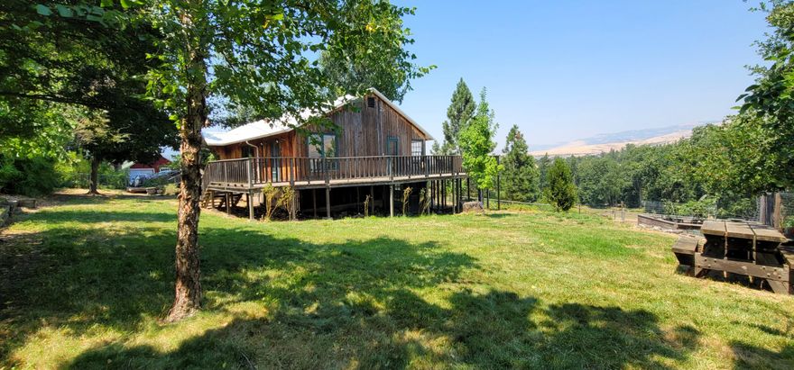 Incredible Opportunity! Extraordinary property offers perfect blend of seclusion and accessibility, minutes from vibrant downtown Ashland. Cherished by the same family for over 40 years, estate spans 10.83 ac across 3 tax lots, zoned EFU, bordering Ashland's urban growth boundary and North Mountain Park & Nature Center. Bear Creek adds serene beauty and abundant wildlife to the property. Irrigated with TID, ensuring ample water for all your agricultural needs. Recent Home-site Approval on TL #4000-2700 provides incredible development opportunities. TL #4100 features a charming 1920s farmhouse 4 bd/2 ba, daylight basement, and utility rooms. This vintage home presents an exciting project for restoration enthusiasts, complete with city water and sewer. The property is well-equipped for agricultural or hobby farming endeavors, featuring a barn, chicken coop, corral area, and shed.  As-Is Sale allowing you to reimagine this magical setting!