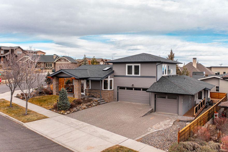 This home hits the mark on so many levels: location, floor plan, finishes and is ideal for multi-generational living or rental income opportunities. Situated on a corner lot this newer prairie style home is beaming with fine finishes & features like vaulted ceilings and exposed beams, floor to ceiling stacked stone gas fireplace, custom kitchen cabinets & bathroom vanities, custom built-ins and new LVP flooring throughout the main level, all of which make the home bright, intriguing & standout from the rest. The floor plan is brilliant with the primary, with its own private deck, on the main level and an attached private guest quarters that has its own exterior entrance, separate bedroom & great room, its own single car garage and a private deck with a side yard. This unit can be completely locked off from the main home, perfect for rental possibilities or has direct access to the home, ideal for multi generational living. Located on Awbrey Butte you are minutes from the heart of Bend.