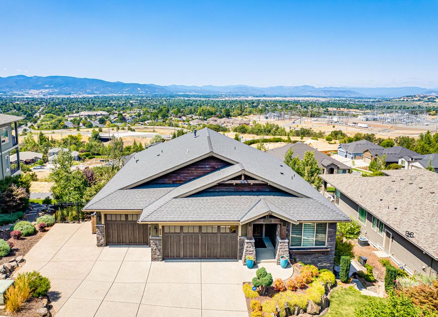 This magnificent home is located in the desirable East Medford hills. If you are looking for a home that has space and spectacular views, this is it! Open floor plan, vaulted ceilings, beautiful rocked archway, large great room w/ gas fireplace on the first floor. Kitchen offers quartz countertops, stainless steel appliances, large island and walk in pantry. Master is on the main floor with a spa like bathroom, walk in shower, soaker tub, walk in closet & Dual vanity. Downstairs you will find 2 bedroom suites, 2nd' great room with amazing tile flooring, 2nd laundry room, Billiard room, wet bar, office and theatre with 7.4 stereo surround and subwoofers under each seat, an office and a storage room. Hunter Douglas window coverings throughout the home. The backyard is a parklike setting including a gorgeous pergola, two large timber teck decks with automated shades. 3 car epoxy floored garage with new age garage cabinets. The list goes on and on, this is a must see!