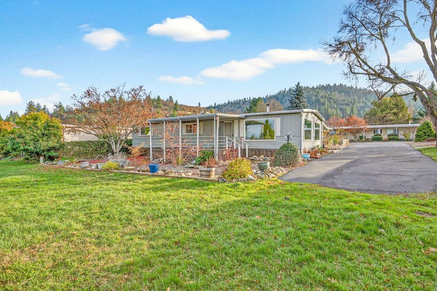 Located in a desirable park, this beautiful home blends warmth and style. Enjoy the cozy efficiency of a woodburning stove and kitchen featuring StainlessSteel appliances, tile countertops/backsplash, and buffet-style cabinetry ideal for hosting.

Situated at the end of the road, the home offers privacy, minimal traffic, and a spacious open area in front plus a large covered porch. Nestled in the foothills of the Siskiyou Mountains, this quiet park provides a peaceful Southern Oregon setting while keeping you close to the amenities of Medford and Jacksonville.