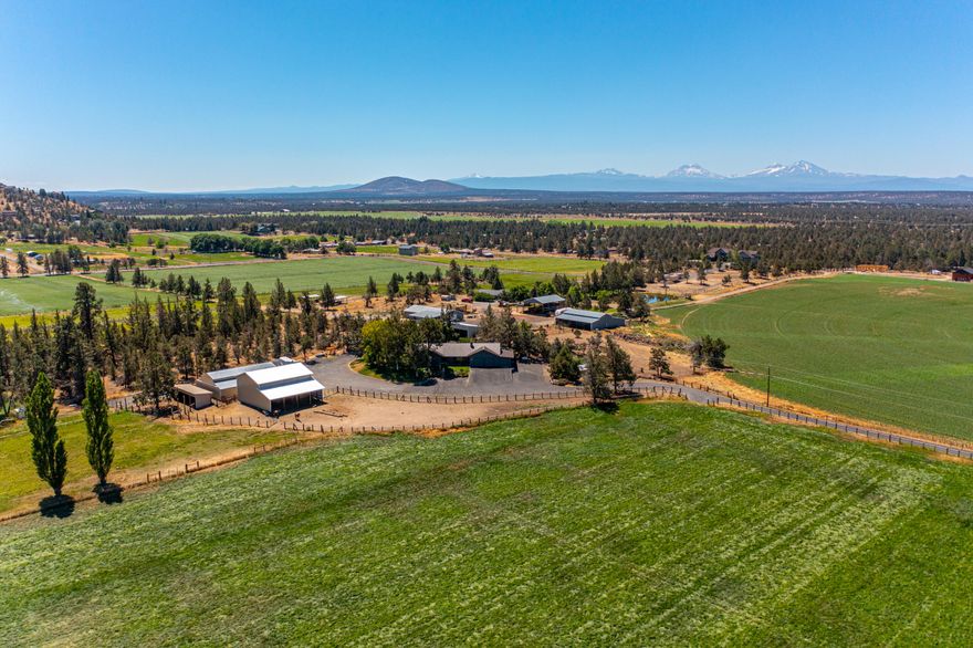 Spectacular setting in the heart of Central Oregon, this property is nestled between Smith Rock and the Cascade Mountains with views that will take your breath away. This single level home offers 4 beds, 2.5 baths, a 4-car attached garage and has undergone extensive renovations over the past 12 months including bathroom updates, new flooring, paint, windows, countertops, and more.  An asphalt driveway leads from Sedgewick to the main house, set on the south end of the property for supreme privacy.  The fully fenced and cross fenced property features 13 acres of coveted COI irrigation rights, pasture areas, multiple barns, machine shed and grid-tied 12 kW solar array which provides most of the power used annually for the home. Buried main line and wheel lines feed the irrigated land which produces roughly 55 tons of hay in three cuttings. This slice of heaven offers so many possibilities for its future owner and is located just one country block from more than 1000 acres of BLM land.
