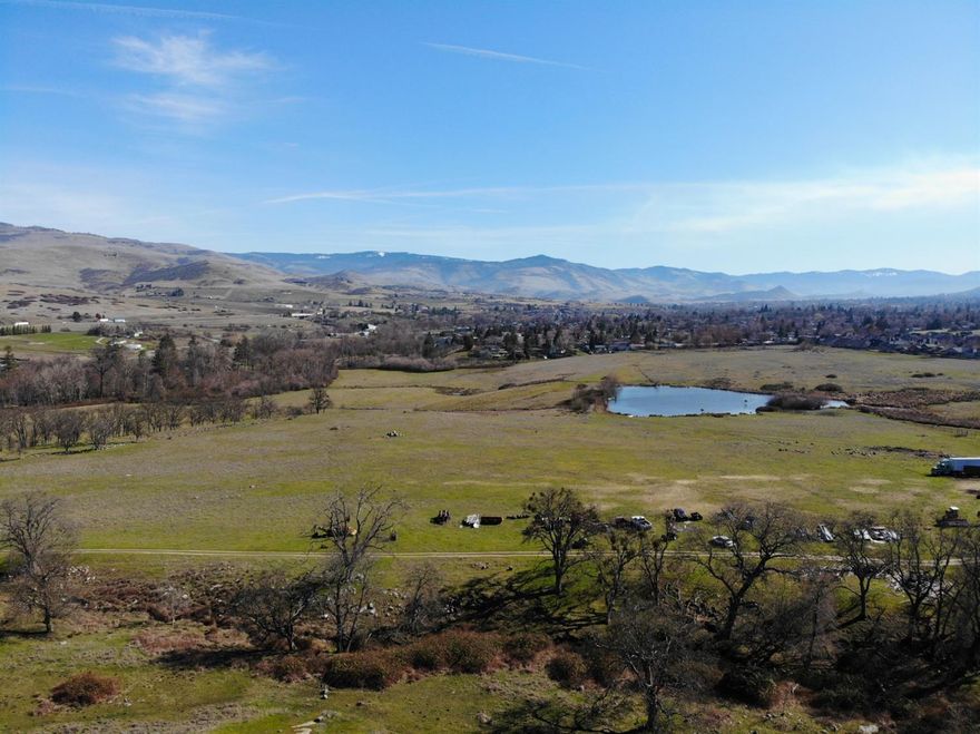 One-of-a-kind historic Billings Farm legacy property in Ashland, Oregon! First time on the market since 1872. This 139-acre property is made up of 3 tax lots and is the largest single property contiguous with the city of Ashland. FOUR different water rights from Wrights Creek, Ashland Creek, Talent Irrigation District (TID), and the iconic Billings Pond give this property the capacity to irrigate more acreage than it has. Year-round creeks, Bear Creek and Wrights Creek, run through. The historic Billings home was built in 1867 and has 5 bedrooms, 2 bathrooms, 2,126 sqft, hardwood floors, central heating & A/C, fireplace & wood stove, and 2 walk-in closets. Large 1880's equipment/livestock barn with dairy barn addition, several grain bins, and EFU-zoning makes this property suitable for cattle-ranching, farming, horses, or livestock. Buyers to do due-diligence regarding the current UGB, the possibility of annexation, and potential future development.