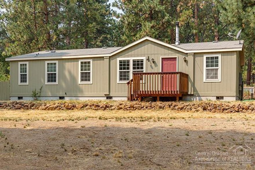 Immaculate manufactured home on a full foundation! This home is move in ready- featuring vaulted ceilings, a certified wood stove, updated guest bath and flooring, & a 1200 SF shop w/10' walls, windows, 100 amp 220 service, and a 16' double door. Sited on over half an acre fully fenced, this property is an outdoor oasis- with front and backyard cedar decks, raised garden beds, canal access, and a large front yard with mature landscaping. This property will qualify for FHA/VA.