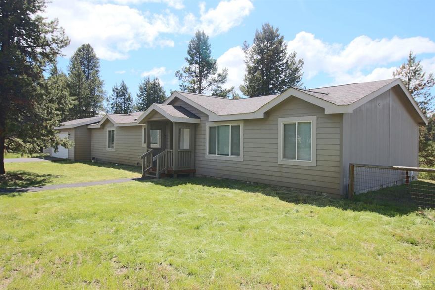 This is a wonderful property with a manufactured home with special amenities: vaulted ceilings, gas fire place in the great room, work out room or office space adjacent to the master bedroom, large kitchen area with an island and hosting lots of cabinets yet open to the great room, a 20' x 30' attached garage, walk in closets in the master suite, utility room and more all on the Little Deschutes River. The property is fenced so move in ready and on 1.63 acres per Deschutes County.