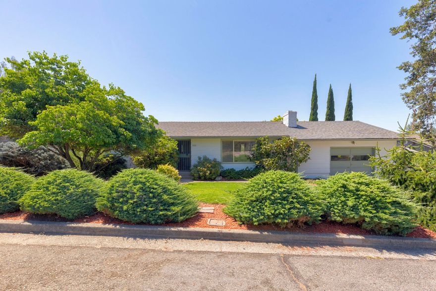 Well cared for home on a quiet street in a superb northwest location of Grants Pass.  Close to schools, shopping and urban activities. New carpet and paint, and with a newer quality roof. Generous living areas includes both living room and a family room. The back yard is large and suitable for gardens, or your choice. And off the dinette is a wonderful deck with panoramic views of distant mountains. Alongside the garage you have an RV parking space.