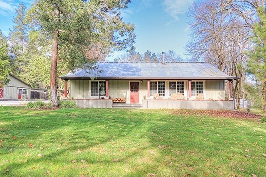 Beautiful Home and Property in Williams! Fantastic Single-Level Home with a Wonderful Spacious Open Floor Plan, Vaulted Cedar Ceilings, and Tile, Wood and Granite Finish Details. You will love the Beautiful Kitchen, Huge Pantry, and the Large Covered Front Porch. In addition to the Main Home, you will fall in love with the Charming 616 Sq Ft Guest House. A Huge 56x30 Multi-Purpose Shop Building features a Craft Room, Workspace, Hot Tub and Sauna, and a Turn-Key Furnished Media Room. Numerous other Outbuildings including additional Storage and Workshop Space, Two Car Garage, Carport, and more. Other amenities include RV Parking/Hook-Up, Level Useable Land, Creek, Established Orchard/Grapes and Wonderful Landscaping. Every aspect of this Home & Property is immaculate. The Land is Partially Treed & would be perfect for Animals. Bridge over Creek provides access to the Rear portion of Property. Incredibly well-done and charming in every respect. A wonderful Home and Property!