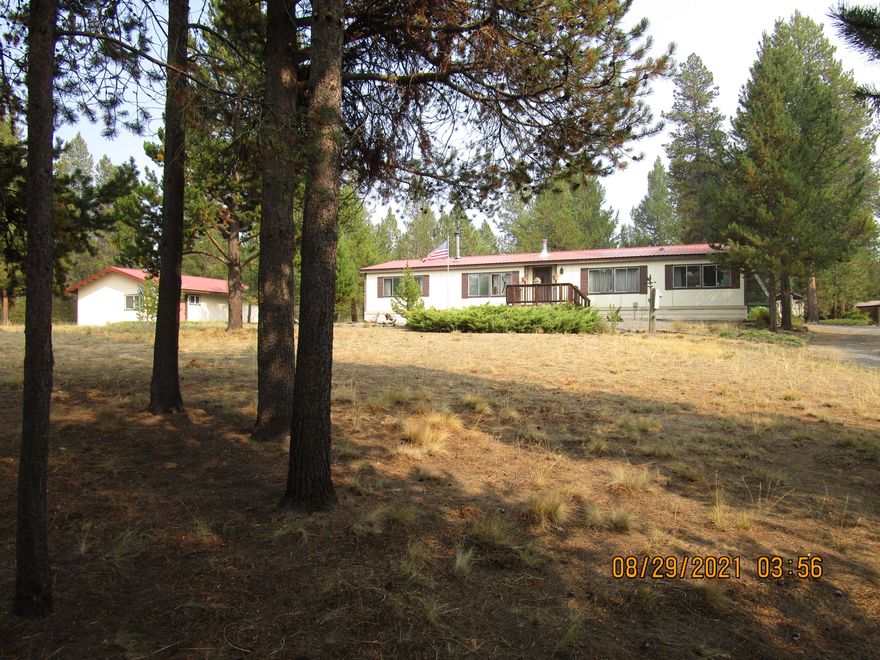 Large 1848 sf ft  Home with a Great Floor Plan. Family Room and Formal Living Room separated by double-sided wood-burning Fireplace. Open Kitchen, Dining Room.  Lots and Lots of built in storage and a huge covered Patio.  Detached double garage with adjoining shop and office. Large open RV Structure. 2 Additional Storage Buildings. Located in a Lovely Neighborhood. Great Privacy.  Backing to acres of Beautiful and well maintained BLM Land.