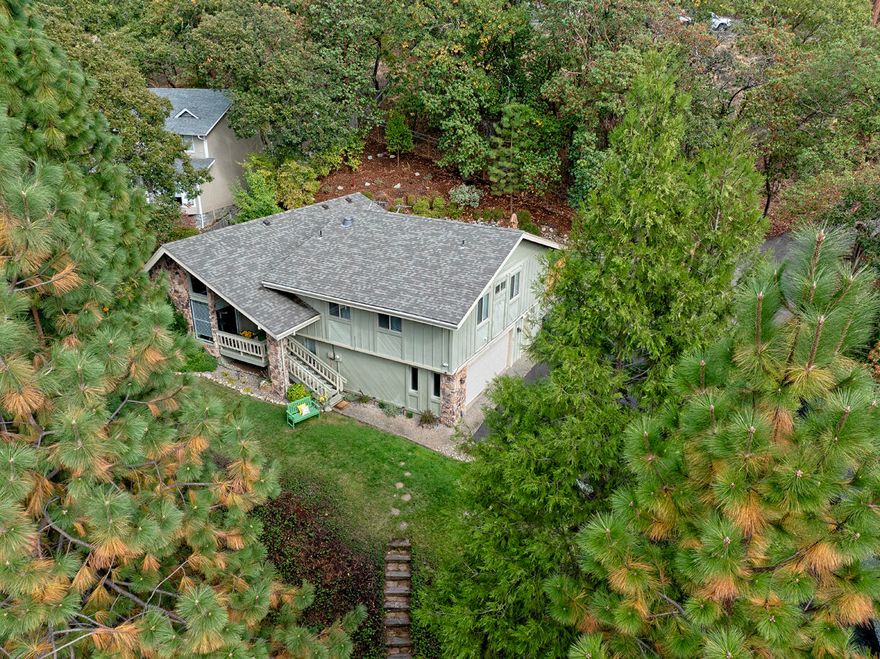 This charming 3 bedroom, 2.5 bath home offers comfort, style, and beautiful mountain views on a peaceful 0.24-acre lot. Enjoy quiet mornings on the inviting front porch, or step inside to soaring ceilings with wood beams and an open, light-filled living space. The updated kitchen features granite countertops, stainless steel appliances, and a sunny breakfast nook that opens to the back deck and easy-care yard—perfect for barbecues or morning coffee. Recent improvements include a new roof (2021), new HVAC with Google thermostat (2020), asphalt driveway, bamboo and laminate flooring and new French drains in the backyard for added peace of mind. Upstairs, two spacious guest bedrooms share a full bath, while the private primary suite offers deck access, a relaxing soaking tub, and a generous walk-in closet. Thoughtfully maintained and full of character, this home is ready to welcome you.