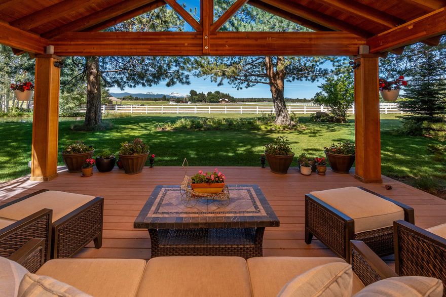 Custom one level Tumalo home nestled on 9.97 serene acres with Cascade views just 15 minutes from downtown Bend.  Relax and enjoy the peace and tranquility watching the sunset over the majestic Cascade mountains on your shaded covered deck. Six acres of worry free inground automated sprinklers create a park like setting. Immaculate open floor plan with primary and secondary suites, 3rd bedroom plus office and 3.5 bathrooms. Chefs granite Island kitchen with Subzero frig, stainless steel Wolf appliances: double wall ovens and downdraft island stove. Large walk in pantry. View breathtaking mountains from you private master bedroom with fireplace.  Master bath with radiant heat, soaking tub, dual head tiled shower, double vanity and spacious walk in closet.  1,800 sqft heated 3 bay garage with Bunk house, 1/2 bath and shop area. Additional 1,440 sqft barn with horse stalls and equine corral.  Entire 10 acres has no maintenance white vinyl fencing. Full RV hook-up.