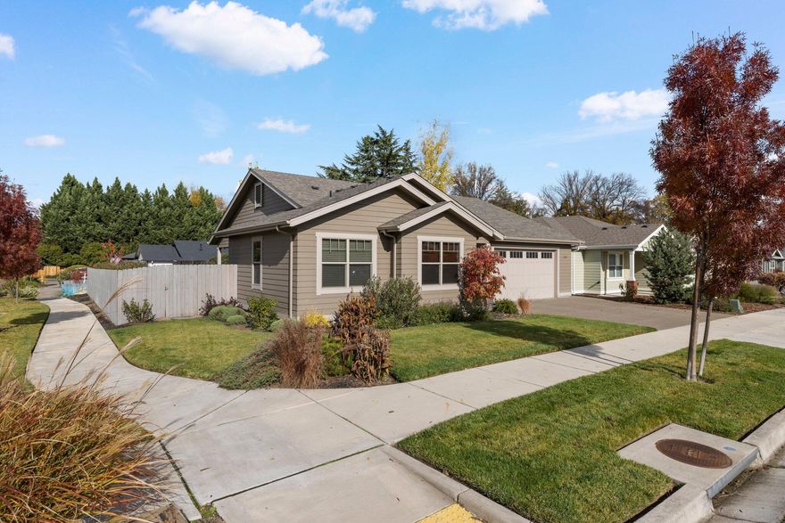 This 2019 built single level Contemporary is better than new! Loads of seller upgrades, completely stylish & immaculate. Wonderful corner lot with beautiful light that streams through the large picture windows & fills the upscale great room. You will love the clean lines & high-end materials. Open concept with 9' wood beam ceiling, gas fireplace, gorgeous chef's kitchen & lovely dining area. The kitchen features a deep island with quartz counters & spacious dining bar. The designer colors & subway tile backsplash, 5 burner gas range & GE stainless refrigerator make this kitchen a delight. Open dining room overlooks the rear covered patio & yard with lush lawn area. The rich hardwood floors throughout the main living areas, custom lighting, oil-rubbed bronze hardware & designer touches elevate the aesthetic. Fabulous split floor plan - primary suite with walk-in & lovely bath with heated floors. 2 additional bedrooms, 2nd bath & utility room. Oversized attached garage. Perfect!