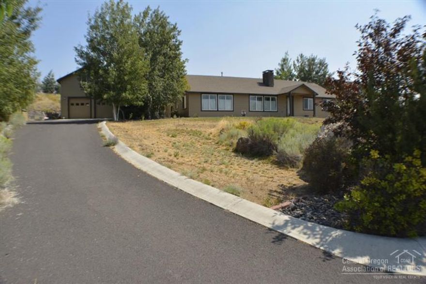 Looking for Cascade Mountain Views, you can see from Mt. Bachelor to Mt. Jefferson? This home is located on 1.97 acres of land across from a large common area that backs BLM. New exterior paint on this single level home that also has a detached shop with living quarters on the 2nd level. Hardwood & tile floors as you walk into the house, vaulted ceilings, granite counter tops, fireplace in the great room, lots of custom designs within this home. RV parking, asphalt driveway.