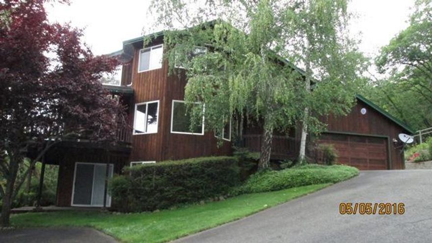 City Views! beautiful cedar home on 1.4 wooded acres overlooking the city. Set back off the road for privacy. Features 3 bedrooms, 2.5 baths, approx 2667 sf, sun room, slab granite counters and cherry stained cabinets, island, newer stainless steel appliances, vaulted ceilings, hardwood floors in entry and kitchen, heat pumps, covered decks, travertine tile in master and guest bath, family room and lower level bedroom could be perfect for 2 family set up, mature landscaping, basketball court, water fall water feature, security gate, just a real quality built house. All information deemed reliable but not verified, anyone interested in the purchase of this property should perform their own investigation into condition and use of property.