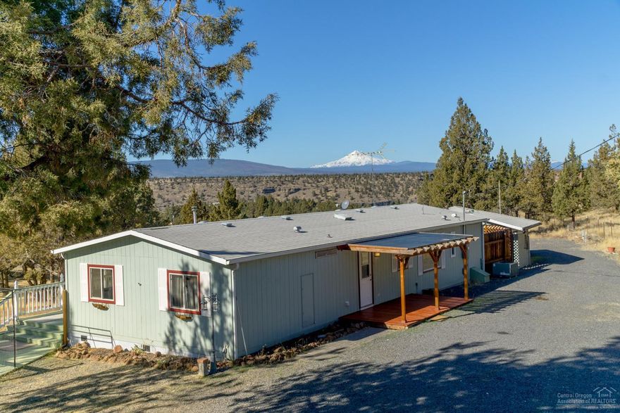 Stunning views from this CRR home. Situated on 1.73 acres of low maintenance property, this home offers views of the Cascade Mountains from every corner. Expansive deck, private hot tub area, outbuildings & a move in ready home. Open living area w/newer carpets, dining room & well separated Master Suite. Plenty of space in the kitchen w/like new appliances. House comes w/ALL appliances! (washer & dryer too) Full RV hookups @ graveled RV pad, fenced yard & outbuildings offer tons of storage. Covered deck!