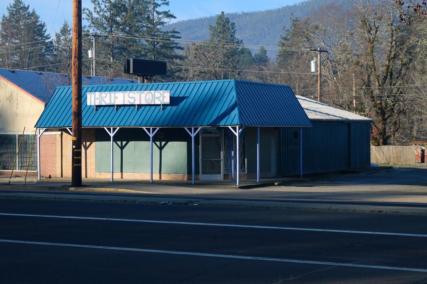 Over 2000 sf commercial business building with very high visibility on the main highway - Redwood Highway / Highway 199 in the heart of Cave Junction's business district and right at one of the city's signalized intersections. Great signage comes with the building, the electronic message board is included. Street parking right in front and a large parking lot in the rear with great easy access along the side of the building. Lots of window display room and a wide open inside providing a clean slate for your next business location.