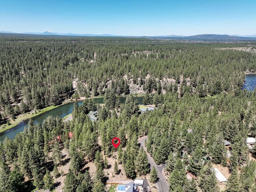 Discover the perfect canvas to build your dream home - and your dream life - in beautiful Bend, Oregon. This gently sloped lot is nestled among towering pines and offers breathtaking views of the Deschutes river. Located at the end of a quiet, pave Street, the setting is as peaceful as it is picturesque. Set above a gated community of waterfront homes on small acreage, this property enjoys a rare combination of privacy, character, and protected views. Whether you are envisioning a private retreat, or a legacy home, this unique lot offers the ideal blend of nature, seclusion, and prime location. Don't miss your chance to create something truly special in one of Bend's most enchanting areas.