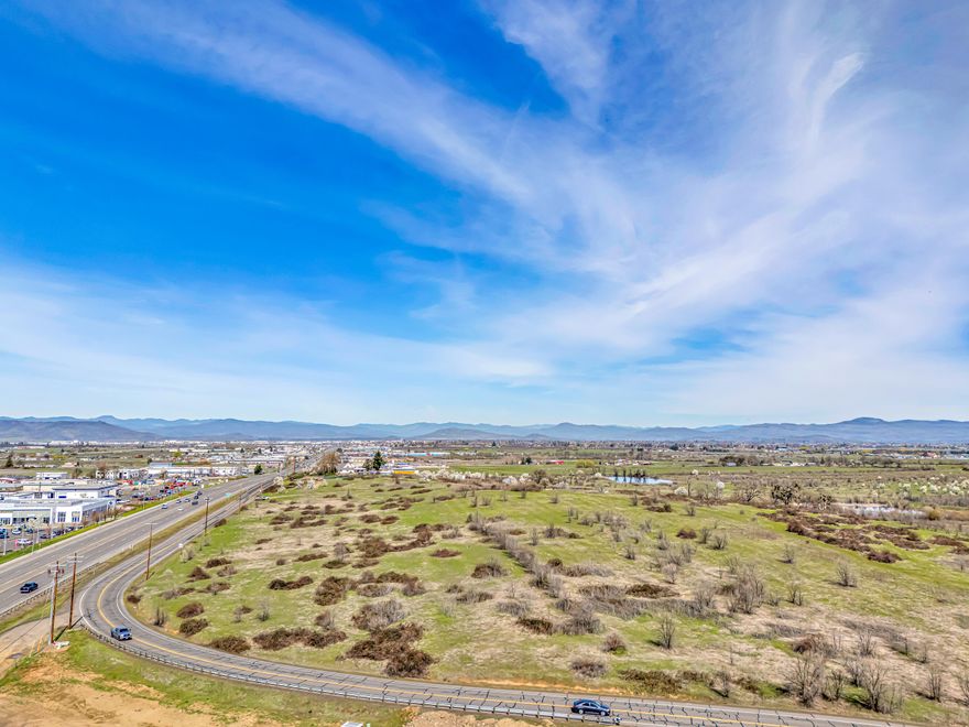 Prime Development Opportunity: Just outside Medford sits a coveted 12-acre parcel with commercial zoning already in place for apartment development. This Opportunity Zone property offers exceptional tax advantages for investors while accommodating up to 300 residential units. Future residents will enjoy a tranquil setting with stunning views, all while maintaining easy access to urban conveniences. The strategic location combines peaceful surroundings with proximity to amenities, creating an ideal living environment. This investment delivers immediate tax benefits alongside strong long-term growth potential in an increasingly desirable market. Don't miss this chance to design and develop the next standout addition to your investment portfolio.