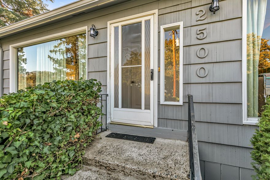 Welcome to this 1950' s Daylight Rambler located off a quiet street in East Medford. Great territorial and mountain views from this larger .29 ac lot.  Enjoy all one level living with a large rec room on the lower level. The perfect split floor plan with primary  bedroom leading out to the covered back porch & hot tub. Home features a large country kitchen with newer appliances and eating area. The home also has a formal dining room which leads into the welcoming living room with a cozy fireplace. Hardwood flooring throughout. Enjoy the sunroom which takes you out to the back patio with views of the surrounding mountains. Some other home features, new 30 year roof in 2016 and new heat pump in 2020. Lots of storage in garage, attic and closet space.  Seller has done a great job with current upgrades and maintenance. Easy care mature landscaping surrounding the home. In addition to the 2 car garage there is abundant off street parking with access off of Capital Av. and Bradford Way.