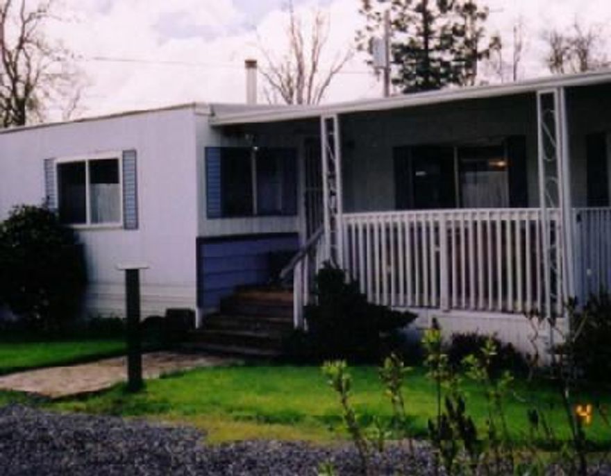 A lovely country, family park. This hoome is a must see to appreciate how a mobile can become a decorators dream. Nice open living room w/antique type wood burning stove. Built-in china closet in dining room. Front kitchen is designed with more than ample storage. Bedroom has an unique designed wall finish and a painted mural. Built-in chest of drawer and vainty counter. Large covered deck at front entrance w/a brick sidewalk. Close to water sports on the Rogue River and a country golf course. Space rent is $235 per month, water, sewage and garbage included. Space backs up to a lrg open field.