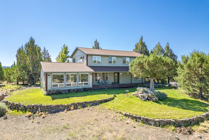 Traditional home on 10 ACRES with CASCADE MOUNTAIN views! Bring your horses and ride out to adjoining BLM land. Large family room with a gas fireplace.  Dining area and kitchen with hickory cabinets, granite counters and bamboo floors. 3 PRIMARY bedrooms suites, one on the main level and two upstairs.  One upstairs primary bath has a jetted tub, walk-in shower and double sinks.  Wrap-around covered front porch and a back deck.  1680 SF Shop/Garage with workshop and 3 garage doors.  Green house and machine shed/chicken coup.  Paved/gravel driveway.  Avion water and standard septic system.