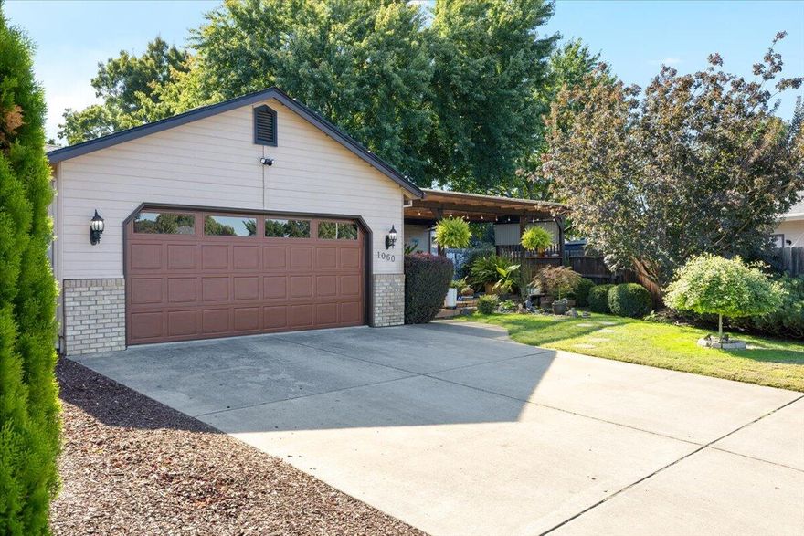 Don't miss this stunning 3 bed 2 bath remodeled Ranch! Nestled in a quiet neighborhood, but close to downtown Central Point shopping, restaurants, and more this home checks all of the boxes. Outside you are greeted by a lush and welcoming covered front porch, tucked amongst greenery for extra privacy. Upon entering you are welcomed in by an open concept living area that is flooded with natural light and character enhanced with arched doorways. The expansive kitchen, complete with stainless steel appliances connects to a dining area with glass doors to the backyard. The primary bedroom hosts an ensuite and walk-in closet, while two additional generous sized bedrooms, a full bathroom, dedicated laundry room, and attached garage complete this smart floorplan. Outside you will find the star of the show, a fully fenced, true backyard oasis! An  expansive oversized deck, and lush mature landscaping provide space to retreat and relax. Take a look today!