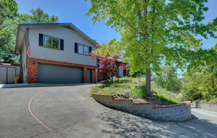 *OPEN HOUSE 5/22/21 11am-2pm* LOOK NO FURTHER! Nestled above the city with captivating mountain views, this 4-bed, 2.5-bath home provides 1980 sq ft of spacious elegance. The freshly renovated kitchen is set to impress with stone countertops, stainless steel appliances, large center island with warming oven. Beautiful maple cabinetry and walk-in pantry provide plenty of storage for all your needs. The open living room features post-and-beam vaulted ceilings with large windows that bring the outdoors in. The massive primary suite offers a walk-in closet, a bay window with reading nook and leads to a private deck overlooking a picturesque backyard. The backyard is a gardener's paradise with a variety of flowers, plants, garden area and custom-made pergola. The oversized garage, capable of fitting four cars, has extra storage and workbench to take on any home project. Home is located at the end of a peaceful cul de sac and is within minutes of downtown Grants Pass. This is a must see!