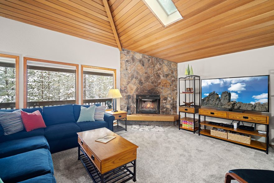 Nestled at the end of a quiet cul-de-sac near The Village and SHARC, #6 Lynx Lane is an ideal family retreat. Enjoy elevated westward views from the Great Room. The kitchen, featuring a skylight above the island, seamlessly connects to the living and dining areas with high, cedar accented ceilings, leading to a cozy covered deck. The floor-to-ceiling fireplace anchors the home. The lower level offers three spacious bedrooms, two baths, and a lower deck with a hot tub. Single-car garage. This property accommodates short-term rentals, making it suitable for a short-term rental, vacation home, or primary residence. Conveniently located for easy access to Sunriver's activities, this residence is perfect for creating cherished memories with loved ones.