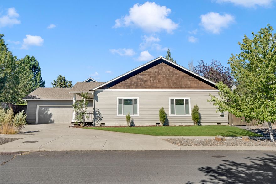 Tucked in one of NE Bend's most desirable neighborhoods, this charming single-level home offers 3 bedrooms, 2 bathrooms, and an open, airy layout filled with natural light. Vaulted ceilings and updated laminate flooring create a warm and spacious feel throughout. The kitchen shines with new stainless steel appliances, generous counter space, and a convenient eating bar. A cozy gas fireplace anchors the living area, perfect for relaxing or entertaining. Step outside to a fully fenced, low-maintenance backyard featuring artificial turf, room for a garden, and space for all your Central Oregon gear. The oversized garage adds even more flexibility. Recent updates include stylish bathroom tile and modern fixtures. Just around the corner from Rock Ridge Park - home to trails, a playground, and a picnic area - and only minutes from the new Costco, schools, and shopping. This home is move-in ready and full of comfort, charm, and convenience