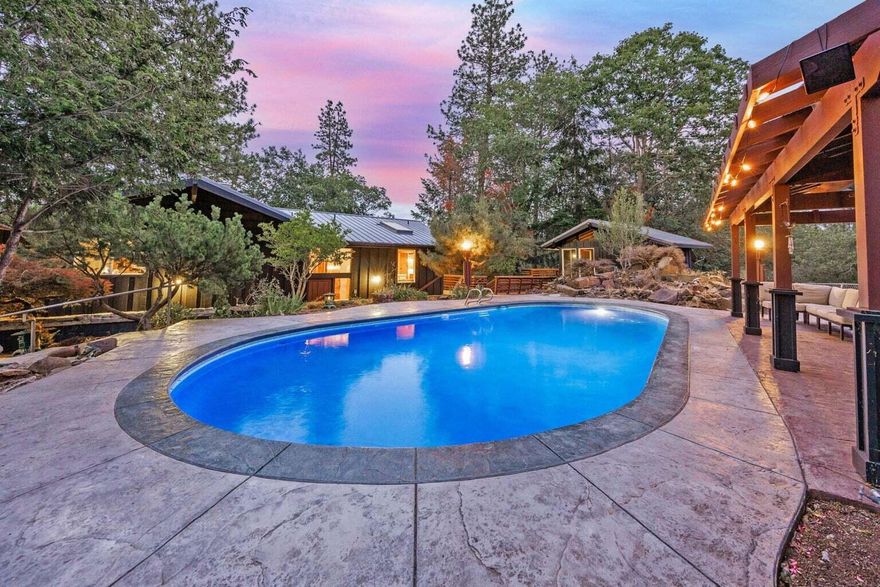 Exceptional Eagle Point Retreat with Heated Pool, Spa and Room in the Garages for 9 Cars! Discover a one-of-a-kind 3,390 sq ft multi-generational home on 1.13 beautifully acres, abutting the Eagle Point Golf Course. The property is a dream for car enthusiasts or hobbyists, with multiple shops. Outside awaits your private resort-style oasis, with heated pool, pergola, separate spa building featuring a hot tub, sauna, and shower. Enjoy sweeping views from expansive decks and floor-to-ceiling windows that flood the interior with natural light. 

Inside, the open-concept great room showcases the custom features of the home. A spacious kitchen and dining area. Massive granite island, abundant cabinetry, large pantry, and seating for a crowd.

Need even more room? A perfect studio apartment, is also included.

Whether you're entertaining, relaxing, or expanding your lifestyle, this home truly has it all.