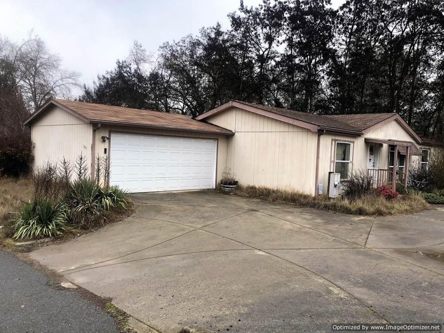 Wonderful opportunity to have over a half acre building lot., right next to the Sport's park. This is a great area of Grants Pass, with lots of city activities close by, AND the Rogue River just a block away! Existing manufactured home is in disrepair but may be able to be brought back to a livable condition. There are many possibilities here! Build your own home or create an amazing income property!