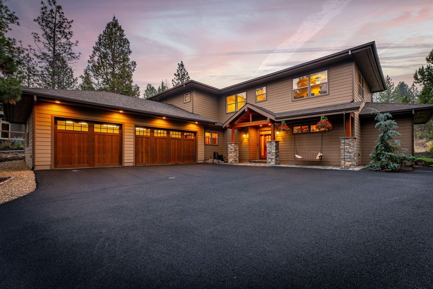 Minutes from downtown Bend, this 2020 custom-built home blends classic design with modern versatility. Expansive windows bathe the interiors in natural light, highlighting the thoughtfully curated finishes. The great room features a gas fireplace framed by built-in cabinetry, flowing seamlessly into the gourmet kitchen with custom cabinetry, a gas cooktop, double oven, granite counters, walk-in pantry, and a generous island. The main-floor primary suite offers a spa-like retreat with a soaking tub, walk-in shower with dual showerheads, and a well-designed walk-in closet. A half-bath and laundry/utility room complete the main level. Upstairs, a versatile bonus room with a wet bar is joined by three bedrooms, two full baths, and a secondary laundry room. Outside, a private sanctuary awaits with a soothing water feature, hot tub, level lawn, and paver patio. A 3-car garage completes this stunning home, delivering the ultimate Pacific Northwest lifestyle.