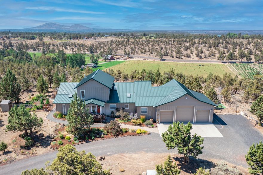 Peace, beauty and mountain views!!  The perfect package in NW Redmond.  This custom built, 2430 sqft home is set on 5 acres and perched at the edge of the rimrock overlooking green farmland and a panoramic view of the Cascade Mountains.  The beautifully finished home features 3 bedrooms and 3 full bathrooms with a first floor primary bedroom and guest room.  The large upstairs 3rd bedroom/bonus room has it's own full bathroom and would be a perfect 2nd primary bedroom, complete with it's own private balcony to take in those Mountain Views!  Enjoy Central Oregon sunsets on the large deck that overlooks the gorgeous backyard, relaxing water feature, and, those Mountain Views!  Large 3 car garage with 1/2 bath and RV Bay with water, sewer connection and 30 amp power.  Quiet country living on a cul-de-sac street just minutes from Downtown Redmond.