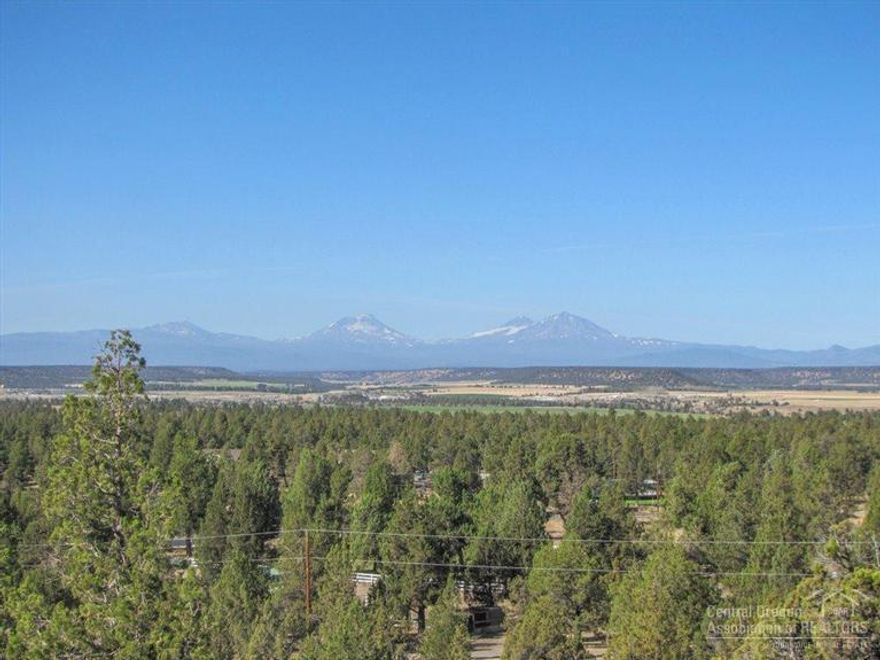 A wonderfully-unique Crooked River Ranch 4.58ac lot, elevated for clear Cascade Mountain & Terrain Views, buffered by mature trees & rock outcroppings for immense privacy, & set for direct access to public land. Property is off all paved roads,not far from the entrance to the Ranch. Road side parcel is level, great for shop or horse barn/corral. Property features: area of shallow wells,power to the North property line, trees/rocks/views for great character,& all the amenities & recreation that CRR provides.