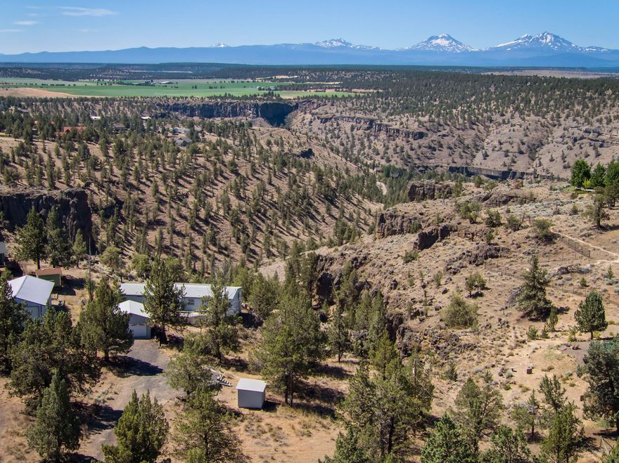 NOT TO BE OVERLOOKED - unbelievably spectacular views in Crooked River Ranch!! An unspoiled picture of the Cascade Mountains and incredible, expansive views of the Deschutes River Canyon make this property something special. The lot has everything you need - a house, two car garage, spacious driveway, and walking trail to the backside outdoors. The vintage 1980's manufactured home, complete with a classic wood stove, is primed for a unique and fun fixer-upper project or ready for a replacement with your DREAM home that boasts incomparably breathtaking views! Crooked River Ranch community amenities include golf, tennis, swimming, and restaurants to make it your perfect rural oasis in Central Oregon.