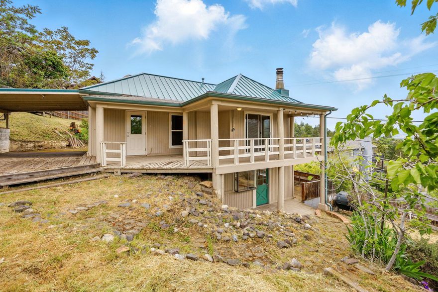 Panoramic views define this 1920s cottage. The light-filled eat-in kitchen features modern cabinetry, granite counters and abundant natural light. Enjoy 3 spacious bedrooms—each capturing stunning views—a large full bath, and a convenient half bath for everyday comfort. Exit outside to tiered outdoor spaces with covered patios, perfect for outdoor dining and soaking in the scenery. Fire-resistant steel roofing, new porch roofs, and fresh exterior paint (2020) add peace of mind. A carport and ample space for gardens.