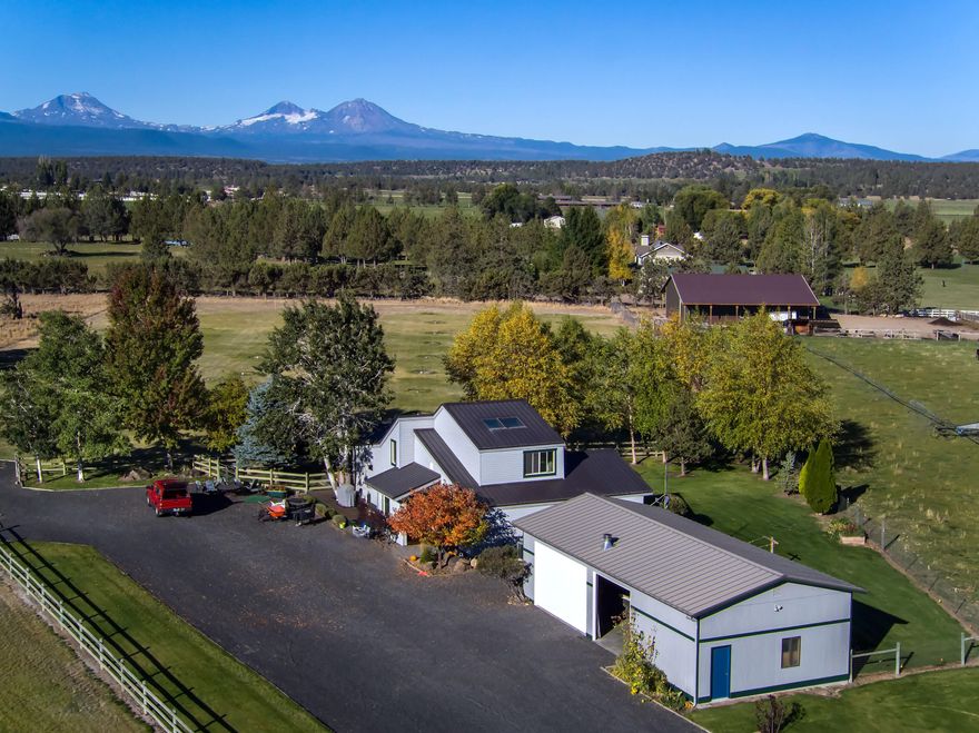 Gentlemen's ranch in the heart of Tumalo with Cascade mountain views. 8.75 fenced acres, 5 acres of underground irrigation on timers for easy care. The home was completely remodeled to the studs in 2007 with a gourmet kitchen opening to the great room.  Main level primary bedroom, office or guest room, plus an upstairs bedroom with skylights.  The west and north sides were expanded for mountain views.  Four stall barn or use as storage and covered RV parking, shop/garage, chicken coop and garden beds. Within minutes to downtown Tumalo.