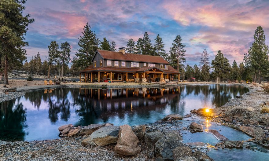 This stunning private ranch offers 79.48 scenic acres with panoramic Cascade Mountain views, a pasture, and a stocked pond in a wooded setting. The NW-style home, designed by Steele & Associates, opens to a vaulted great room with exposed beams and a double-sided wood burning floor-to-ceiling fireplace. In the gourmet kitchen, a large granite island complements Thermador panel-ready appliances, a wine fridge, and hammered copper farmhouse sinks. The main-level master suite offers mountain views, a hammered copper soaking tub, radiant floor heat, and access to a 20' swim spa. A guest room with en suite, two additional bedrooms, and a bonus room complete the second floor. Outside, enjoy the seasons on a large patio with fire ring. Additional features include a 3-car insulated garage and a 4-stall barn with tack room and RV center aisle with hookups. The fenced property, only 6 miles to the community of Sisters, is backed by 160 acres of BLM land and includes 7.5 acres of irrigation.