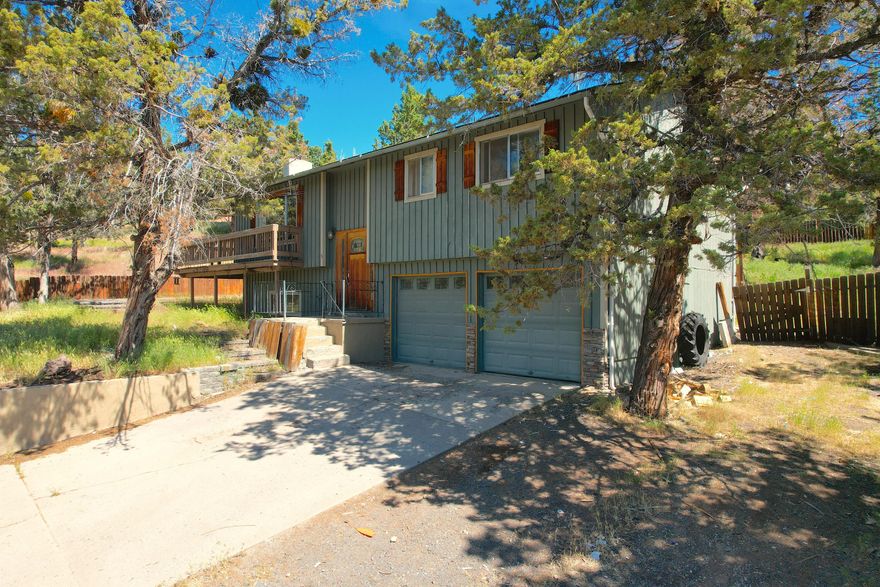 4 bedroom 2 bathroom home in Ochoco West! This 1602 sqft home features the living room and kitchen on the main level, along with 3 bedrooms and a bathroom. Downstairs there is a family room, another bedroom, and bathroom with laundry hookups. An attached double car garage provides ample parking or storage, and a large deck wraps on two sides of the home.  Come enjoy all of the amenities that Ochoco West has to offer. Home and property being sold as is.