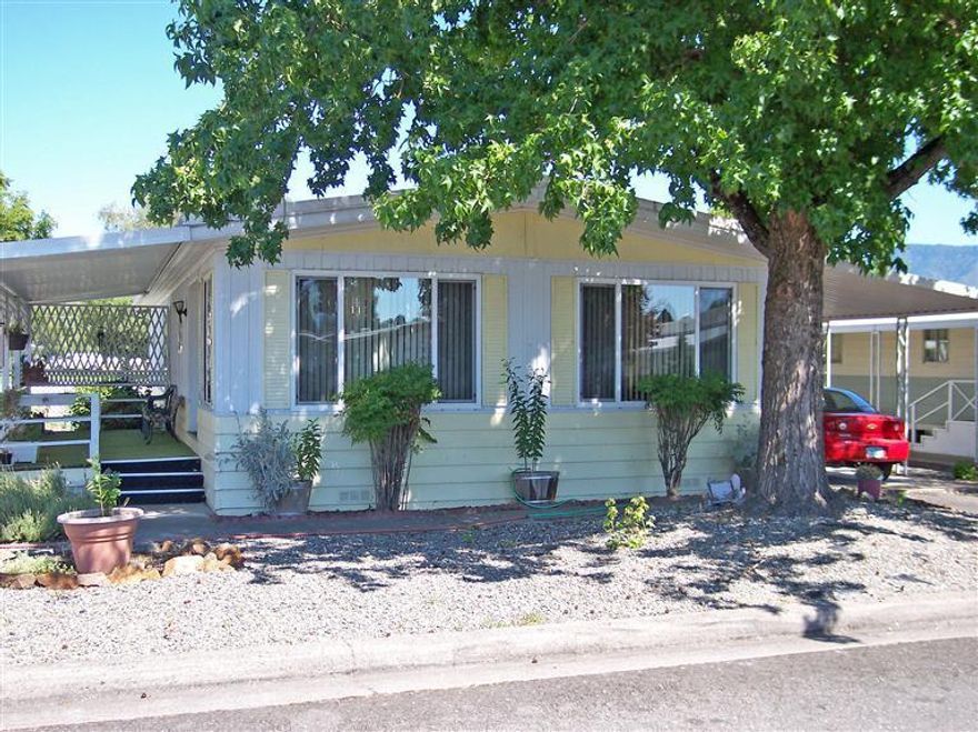 Affordable & Comfortable Double-wide mobile home in Rogue Lea Estates, 55+ Senior Park. The home features 2 bedrooms, 2 baths & a family room. It also has a nice living room, formal dining room with built-in hutch & a convenient island kitchen. All appliances go with the home including the washer & dryer in its own laundry room. Outside is a deck for relaxing & a carport with a shed at the end & another shed behind it. There are raised beds in the backyard for your garden & flowers. The park is ideally located close to downtown, shopping, banks & even the local hospital. There are great, caring neighbors in a safe environment with an active clubhouse & a lake to fish in without a license. Come take a look!