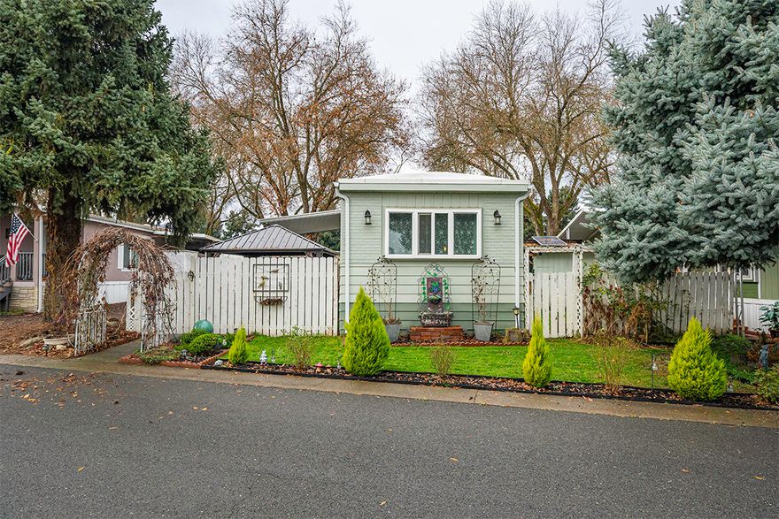 Located between Medford and Jacksonville and nestled in the charming & peaceful Blue Spruce 55+ park! This home has been lovingly updated & features fenced & beautifully landscaped yards, two new & inviting pergolas, plustwo spacious storage sheds with a lean-to. The roof has been updated to a rubber membrane roof for longevity and efficiency, newer paint and furnace motor. New flooring, new lighting fixtures, KitchenAid refrigerator and Frigidaire range/oven. 2 nice-sized bedrooms and a great room with lots of updated double pane windows for natural light. Covered parking. The park also offers an RV/ boat storage area and one of the lowest park rents! Live the good life in this well cared for community. Financing Available.. ask for details!