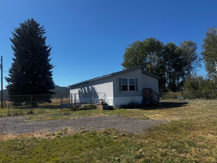 Spacious 3-bedroom, 2-bath manufactured home on nearly 3 acres with 1,456 sq ft of living space. Features an open floor plan, a large kitchen, and brand-new tile flooring in both bathrooms. Plenty of flat, usable land ideal for animals, gardening, or outdoor projects. A solid opportunity with room to make it your own.