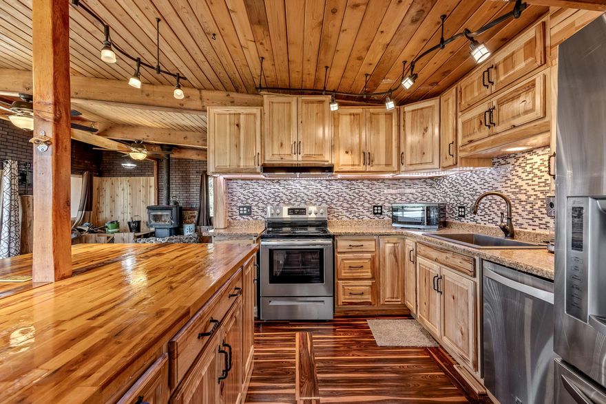 What a great opportunity to own a remodeled cabin on a large lot in Ochoco West. This home has been creatively updated throughout w/ a full daylight basement w/exterior
entrance to a private bedroom and full bathroom. It also has a newly installed mini-split for heating & cooling. Upstairs is a large kitchen w/wood cabinets, updated
counters, appliances, & under cabinet lighting. It has a large island & is open to the great room w/new flooring, wood stove, updated lighting, & windows. Laundry room
has 1/2 bath & lots of room for storage. Primary bedroom w/new carpet, mini-split, updated bathroom w/heated tile, shower w/dual heads, and slider off to patio. This home
feels like you're living in a tree house high above the neighborhood with great views of the valley! Additional 624 sq ft of living space was added to the primary bedroom
and living room. Would be great for dual living or in-law suite down below. Large lot w/storage shed, rv/boat parking, & tons of potential.