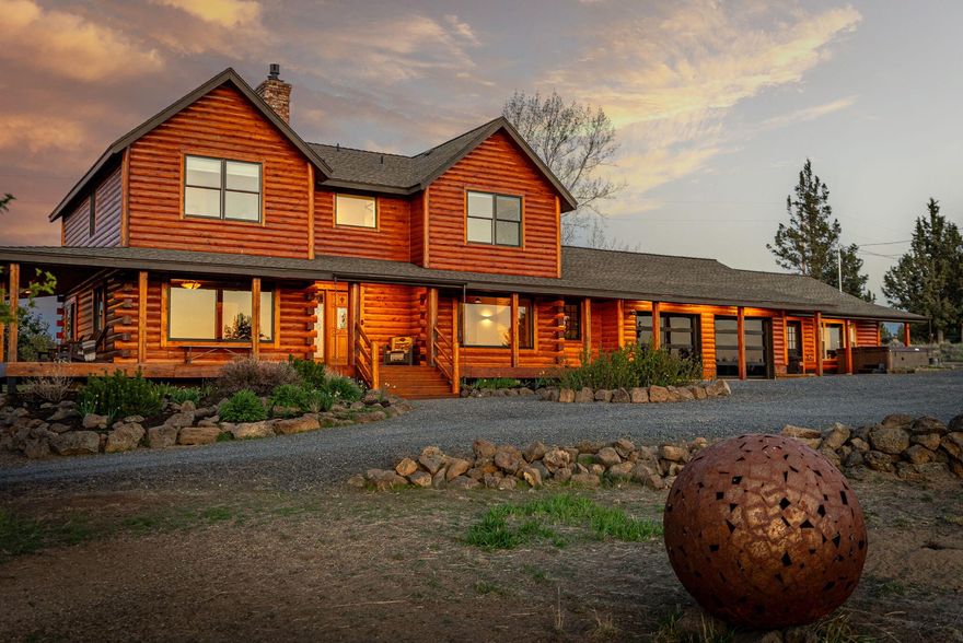 Your dream home awaits you in this traditional handcrafted log home with guest suite/studio situated on 5.53 acres w/like new 3 stall horse barn, newly seeded irrigated pasture & half acre pond w/on-demand hydrants. SE Bend location offers peace & tranquility with breathtaking Cascade Mountain Range views. New luxury updates throughout this beautiful home from the completely remodeled kitchen w/Dacor appliance pkg, custom cabinetry, granite & concrete countertops, butler's pantry & timber beam ceiling to the reclaimed French white oak floors, custom designed live-edge juniper railing and custom Forged Elegance fireplace iron. Home is light, bright, cozy and energy efficient w/wood clad Pella windows.  Too many updates & custom finishes to list. This home is a must see! Imagine relaxing on this front porch while the sunsets wash over the pasture and pond. It's double the view! Property has direct access to over 200 acres of public lands owned by Bend Parks & Rec