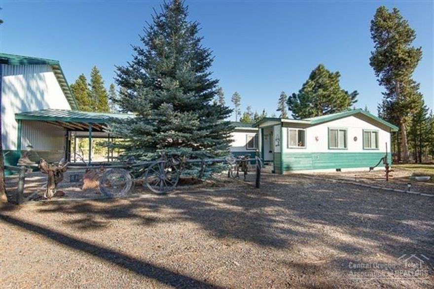 This incredible property has hosted numerous wedding ceremonies and events. Complete with covered outdoor kitchen, 4 full RV hook-ups, field sprinkling and heated eaves- this well loved property has it all! In addition to the living space within the home, there is an 1100 sf bonus room with separate office area above an over sized 2 car garage w/ shop space, bathroom and laundry. Between garage and home is a covered breezeway for snowmobiles or ATV's! 5 outbuildings, all with power and metal roofs too!