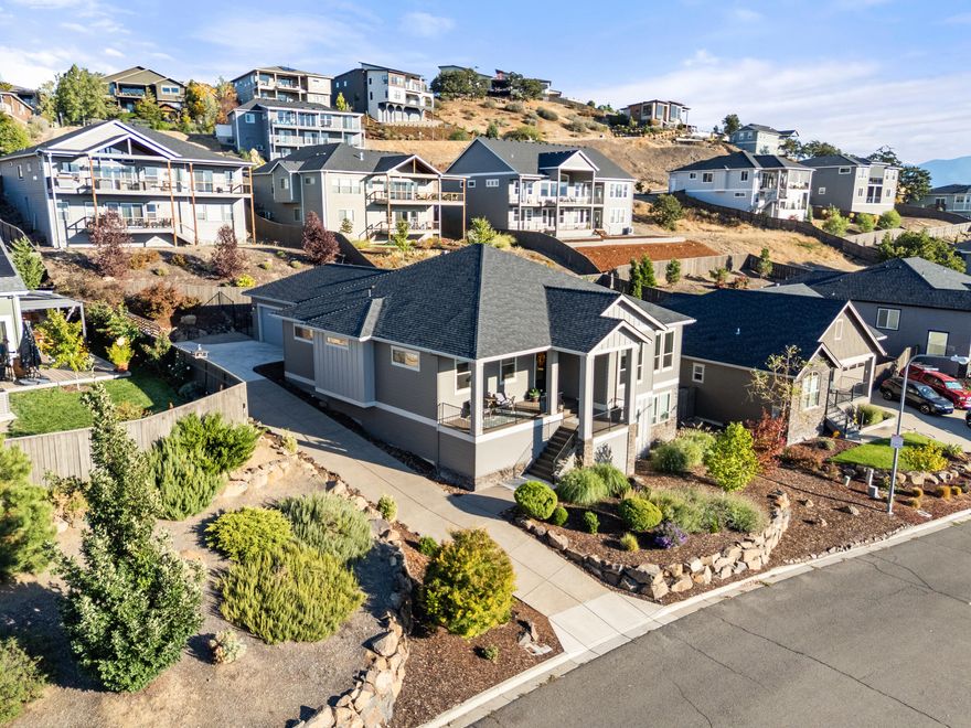 Exquisite 2,500+ sq. ft. custom home on a .23-acre landscaped lot offering refined design, modern comfort, and breathtaking Southern Oregon sunsets. With 3 bedrooms, 2.5 baths, an office, and a sun-filled bonus room that opens to private Trex decks, this residence is built for relaxation and entertaining. Inside, 10' ceilings and dramatic 13' vaults enhance the open layout, complemented by European French oak hardwood floors, 8' doors, designer lighting, and a gas fireplace with custom mantle and built-ins. The gourmet kitchen showcases granite counters, a walk-in pantry, dry bar, stainless appliances, and abundant custom cabinetry. Retreat to the luxurious primary suite featuring dual vanities, walk-in closet, and spa-like tiled shower. An oversized laundry/mudroom with built-ins adds convenience. Complete with a finished two-car garage, fenced yard, lush landscaping, and seamless indoor-outdoor living, this home blends timeless elegance with everyday functionality.