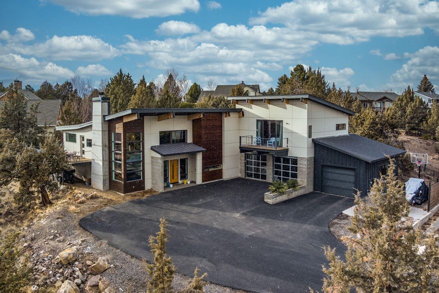 Custom home with amazing views in South West Redmond.  Modern feel with amazing features, this home has heated floors, solid surface countertops, custom cabinetry, 3 car garage with epoxy floors.  Large glu-lam beams and columns, open steel frame staircase with solid wood treads.  Large hot tub out back, patio and shed.  Large primary suite and bath.  Gourmet kitchen with island and plenty of cabinet storage.  Large over sized side by side fridge and freezer, this kitchen is a cook's dream!  Beautiful gas/wood burning fireplace creates a wonderful home, great room feel.  This is a must see with amazing views.  Large lot in town!